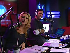 The hosts of Playboy Radio's Morning Show are looking at their guest model who is wearing the dress she'll be wearing to the Playboy Mansion for Halloween. Her head and tits are covered in fake fruit like oranges, limes, lemons, and more. She flashes her breasts for the hosts and viewers.