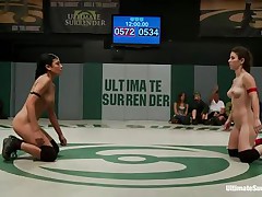 The match is intensive and it appears to be that the referee is looking somewhere else 'cuz things are going wild in the arena. These bitches don't know the meaning of fair play and a cutie comes in the assist of the other one. Looks like someone will need to surrender